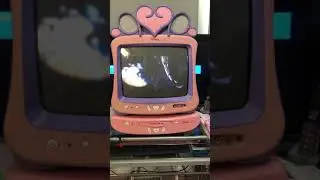 Pink Disney TV with DVD player playing movie