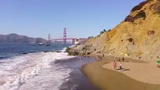Flying over San Francisco Golden Gate Bridge and Baker Beach