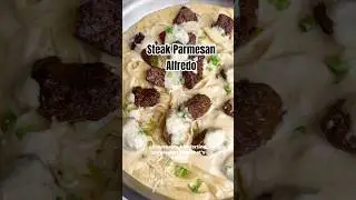 Garlic butter steak bites are topped over a creamy Parmesan fettuccine Alfredo #recipe #shorts