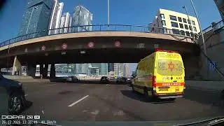 An ambulance overtakes cars on the highway 20 Ayalon