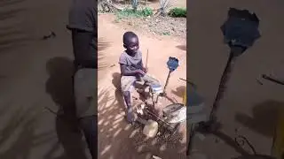 Little boy plays his homemade drum set.