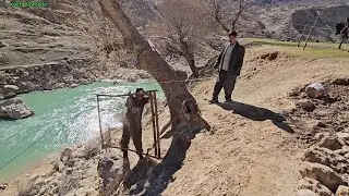 Nomadic life: pulling sand with a wire rope and building a hut wall with blocks by Omid