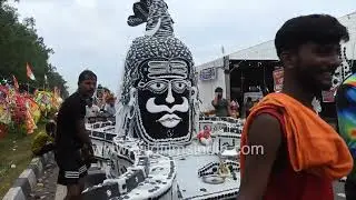 the spirit of the Kanwar Yatra where devoted Kanwar yatris are seen taking a holy bath