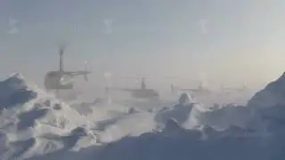 Russian Ice Camp BARNEO, North Pole - April 5, 2015: 4 helicopters ROBINSON taking off one by one.