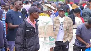Comedy or excitement? A man celebrates a graduation dressed in a sack gown and cap. 