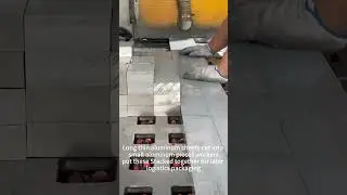 Long thin aluminum sheets cut into small aluminum pieces worker sput these Stacked together