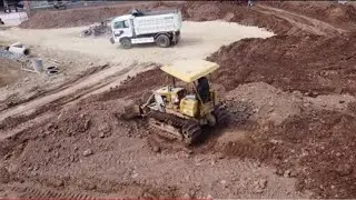 small Damp truck Bulldozer clearing pushing land very smooth
