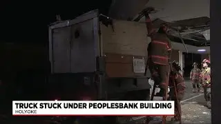 Truck stuck under People's Bank building