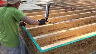 Applying Advantech subfloor adhesive.
