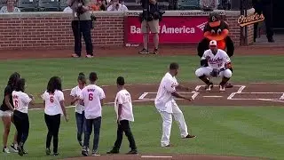 Mora and his quintuplets throws first pitch