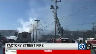 Fire burns through roof of building in Derby