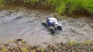 Maverick Scout RC 4x4 rock crawler driving in a creek