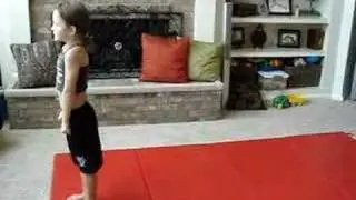 Six year old doing standing tuck on floor