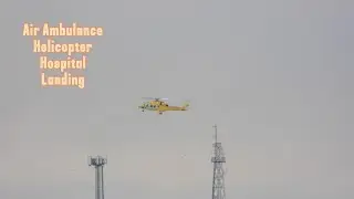 Air ambulance helicopter landing at hospital helipad in Portsmouth, UK