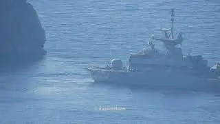 Hellenic Navy Roussen class Missile Boat maneuvering near rocky coast in Aegean Sea.