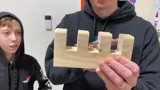 RIDDLE: How do you get a nail inside a block of wood without holes, drilling or cutting?