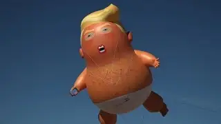 Baby Trump balloon greets Trump at US-Mexico border
