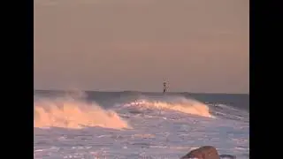 White horses at sunset, Filey Brigg look east to a cardinal bell buoy in heavy seas, Yorkshire coast