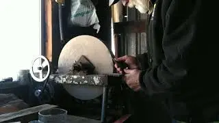 working with an antique grinding stone