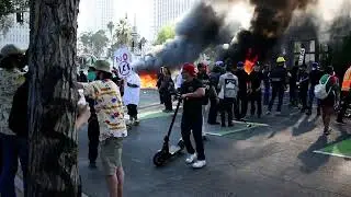 Protesters watch burning Waymo cars downtown Los Angeles June 8, 2025