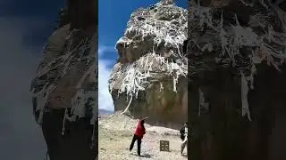 Red-clad Woman Throws Prayer Flags at Sacred Cliff, Wishes Spread in the Sky