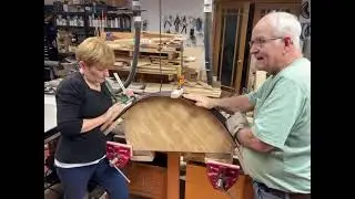 Moving the finish trim piece from the steamer to the shaping form.