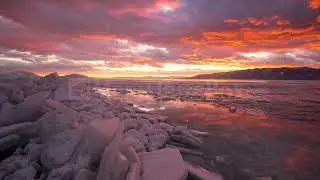 8K Stock Video - Colorful sunset timelapse over stacks of ice on Utah Lake