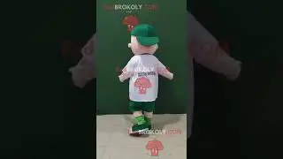 Cheerful Cartoon REDBROKOLY mascot in 'Gois Cup' Outfit - Green Hat - green shorts - white shirt