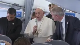 Pope gets emotional as reporter on board papal plane shows him photos of migrants on Lampedusa