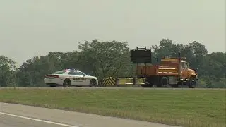 911 call from UPS driver who found weapon along I-70
