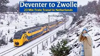 By train from Deventer to Zwolle The Netherlands through a snowy landscape 