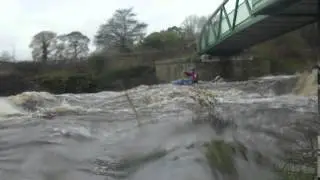 Sam shooting the broken weir on the River Goyt