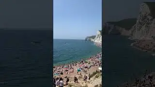 Tourists enjoy the hottest day of year at Durdle Door in Dorset