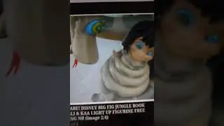 Kaa coils around Mowgli from the jungle book toy