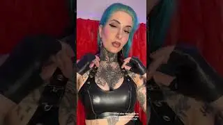 Blue hair, black gloves and buckled latex top