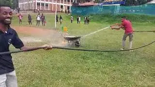 Police officer training civilian how to wind up fire with water .
