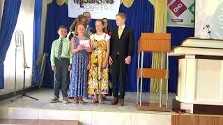 Family singing Swahili Hymn “Tangazeni Neno Lake” “Come Thou Fount”