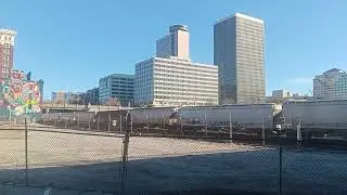 Union Pacific 5545 leading BNSF manifest under  bridge by jack stack barbecue in kansas city mo 