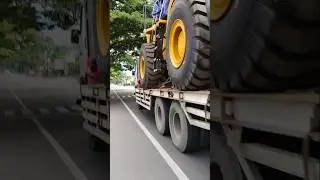 bulldozer vehicle transported by truck