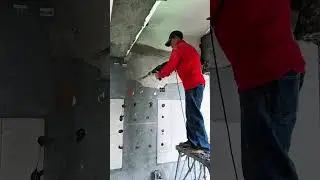 Chipping Away Old Plaster From a Wall Using a Power Hammer