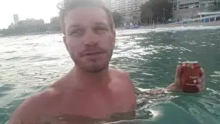 Alicante beach front, in the sea with a beer.