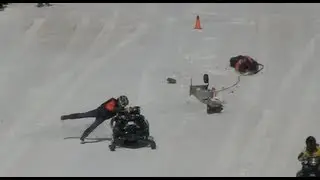EPIC FAIL!  Snowmobile crash, close call for starting line official and driver.