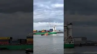 A boat and cargo ship passing through the Port of Tilbury