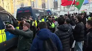 London police officers stop kurdish protesters from marching through to trafalgar square