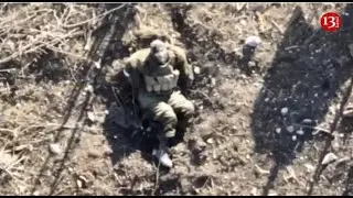Scared to death, Russian soldier watches the drone flying over