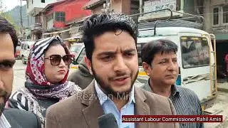 Assistant Labor Commissioner Baramulla Rahil Amin is telling the shopkeepers something important.