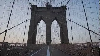 SLOW MOTION: Empty Brooklyn Bridge with no people early morning at sunrise in beautiful sunlight in