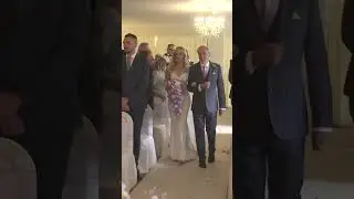 Bride walks down the aisle with her dad