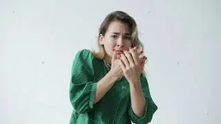 Portrait of beautiful young woman covering face with hands expressing fear and shock
