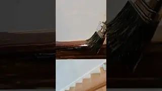 applying stain on handrail